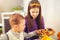 Boy and girl preparing and eating healthy meal at home