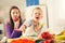 Boy and girl preparing and eating meal