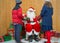 Boy and Girl receiving gifts from Santa