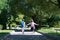 Boy and girl after school with bags full of textbooks returning home through the park holding hands