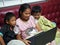 Boy and girl Sit happily watching a movie on your laptop on the red sofa.