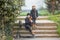 A boy and a girl sit on the steps with a scooter.