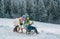 Boy and girl sledding in a snowy forest. Outdoor winter kids fun for Christmas and New Year. Children enjoying a sleigh
