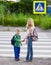 Boy and a girl standing near a pedestrian crossing