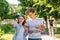 Boy and girl in summer in nature. Holds a roadmap and a smartphone. Indicates direction of movement. Travel around the