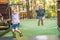 boy and a girl on swings on playground with smile on sunny summer day