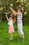 Boy and girl tear the tree flowers inside forest