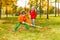 Boy and girl with two rakes working cleaning grass