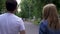 Boy and girl walk together at the park