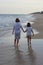 Boy and girl walking on the beach