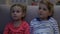 Boy and girl watching tv at night, scared when parents suddenly return home