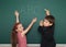 Boy and girl write on school board