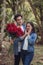Boy gives bouquet of roses to his girlfriend on Valentine`s Day