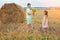 A boy gives a bouquet of sunflowers to a girl on the field. Children in nature