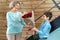 A boy gives flowers to his grandmother at a family celebration. The concept of warm relations between the older and younger