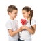 Boy gives a little girl candy red lollipop in heart shape isolated on white. Valentine`s day. Kids love.