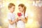 Boy gives a little girl candy red lollipop in heart shape. Valentine`s day