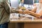 Boy Giving Books To Librarian At Library Counter