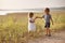 Boy giving bouquet of spring flowers to happy girl