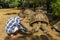 A Boy giving food to giant endangered turtle, animal eating plants outdoors.