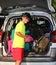 Boy with glasses loaded the luggage in the trunk of the car