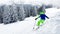 Boy go off piste ski downhill with beautiful snow forest on back