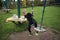 The boy goes through an obstacle course is engaged in active sports sits on a suspended swing