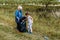 Boy and grandmother do cleaning plastic debris in nature. environmental pollution