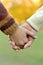 Boy and grandmother hands together over natural background