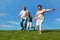 Boy and grandparents running on summer lawn