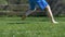 Boy on the grass kicking football in garden - slow motion