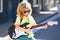 Boy guitarist. Portrait of cute child boy at guitar practice, funny rock child with guitar. Music kids.