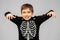 Boy in halloween costume of skeleton frightening