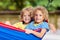 Boy in hammock. Kids play in summer garden