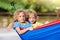 Boy in hammock. Kids play in summer garden