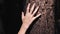 Boy hand gently touches a tree bark in forest at sunrise. Young person carefully explore nature, connect with forest