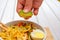 Boy hand squeezing lime on Malay Mee Rebus in the bowl with chopsticks on white table This dish is made of noodles ,vegetable,egg