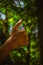 Boy hand with thumb upwards on Heart Bokeh nature background. Showing Positive thumbs up - closeup shot