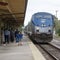 Boy with hands over ears as locomotive approaches