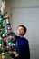 Boy hanging icicles on Christmas Tree decorating