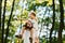 Boy has fun with father in the park on sunny day, both dressed in the white t-shirts. Boy sits on the father`s shoulders