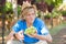 Boy in hat and blue t-shirt harvesting ripe grapes