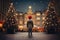 boy in a hat in the central square, looking at large Christmas tree decorated for Christmas, rear view