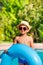 Boy in hat and sunglasses holding inflatable ring