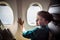 A boy have flight looking in the airplane window or porthole