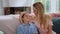 Boy having conversation with mother at home. Mother and son sitting on sofa