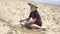 Boy having fun playing with toys and building sandcastles on beach.