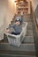 Boy having fun sledding down stairs in a storage box