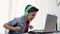 Boy in headphones playing video game on laptop