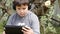 Boy in headphones with touchpad outdoor